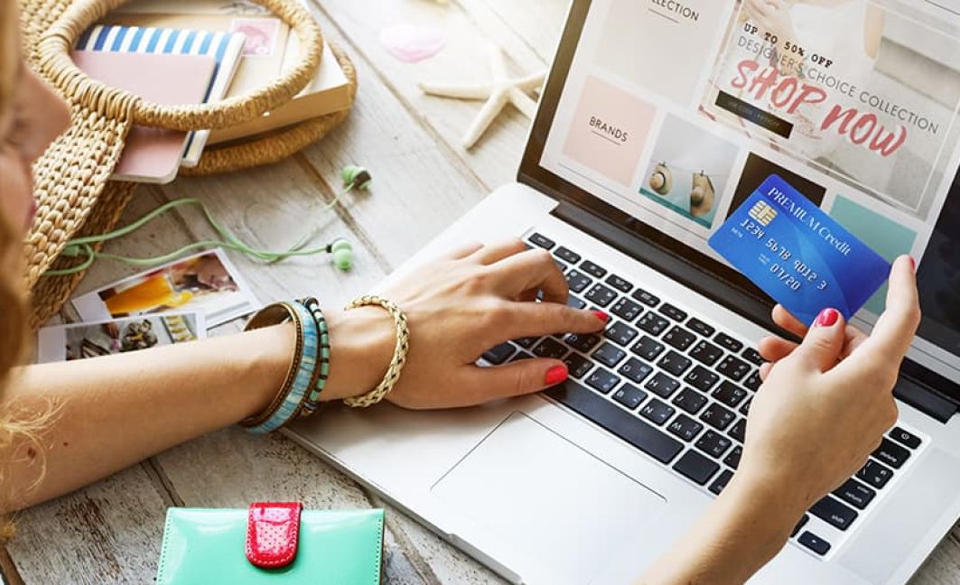 woman using credit card on laptop for holiday sale