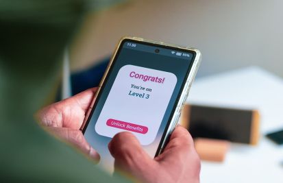 man holding phone reviewing customer loyalty program