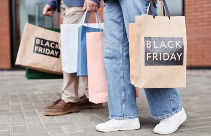 black friday shoppers walking with bags