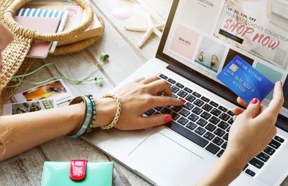 woman using credit card on laptop for holiday sale