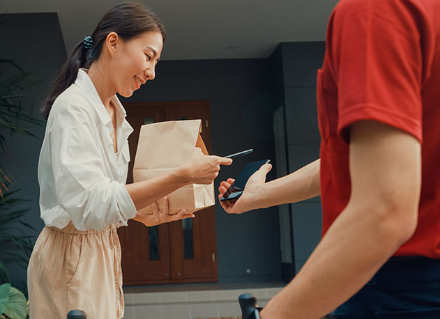 A woman paying with her phone using North's Tap to Pay app