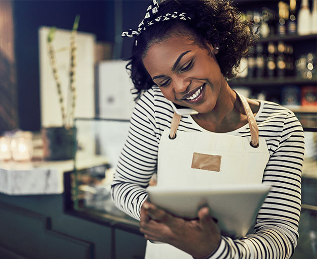 A restaurant hostess on the phone marking down a reservation using North POS systems