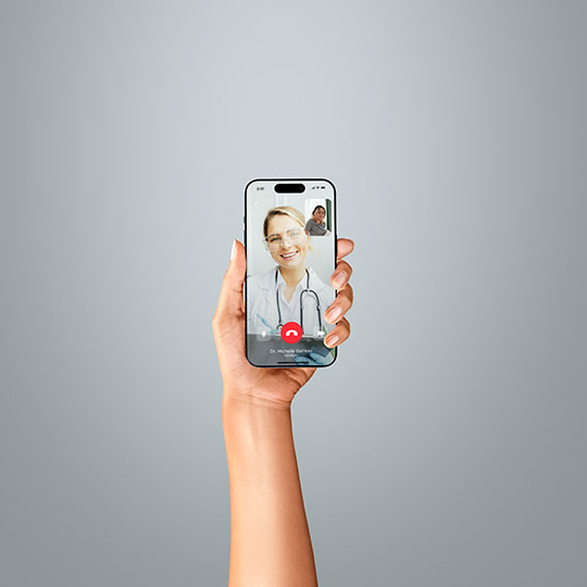 A hand holding a iPhone on a telemedicine call representing the telemedicine industry