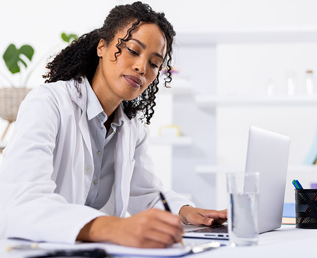 A pharmacist taking notes on customer reports built using North POS systems