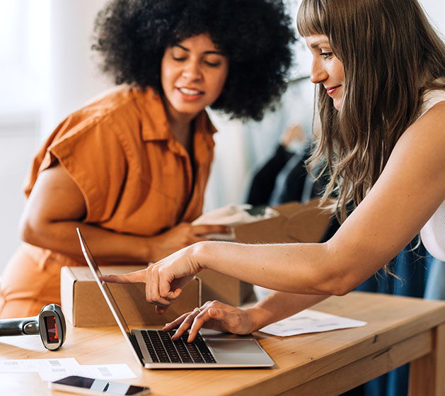 Two female business owners utilizing autopay features on North's POS systems