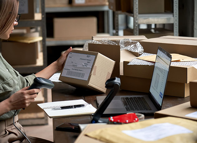 A business owner scanning a box's barcode