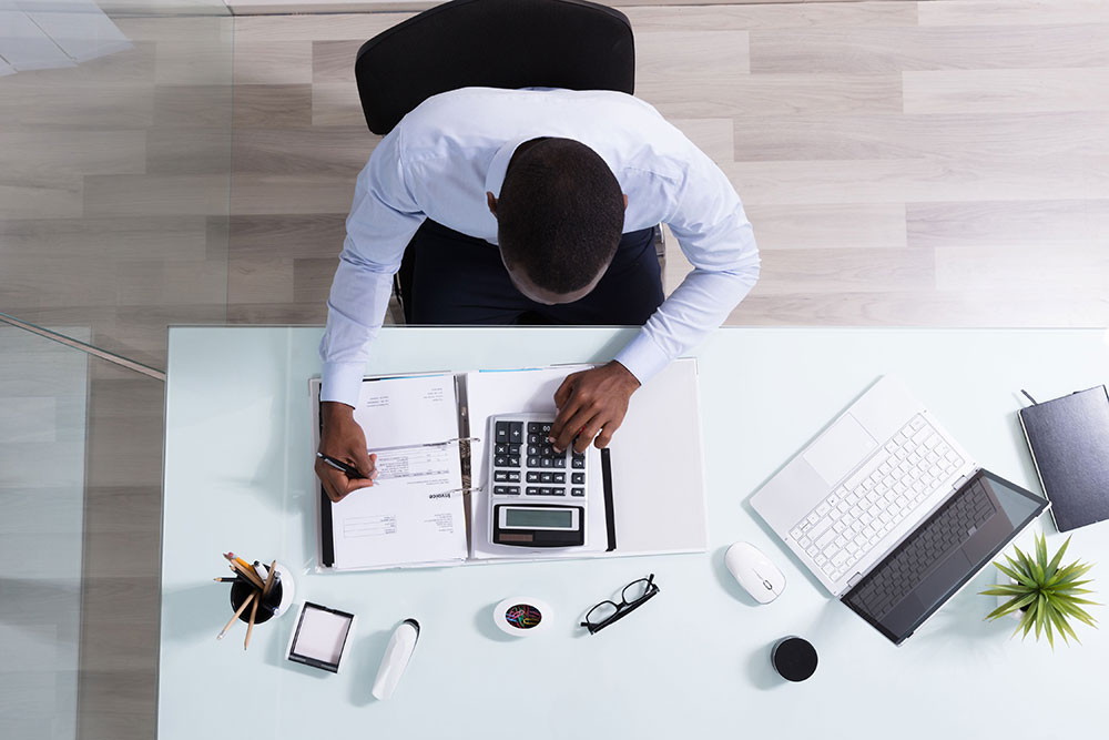 man at desk reviewing merchant services account.